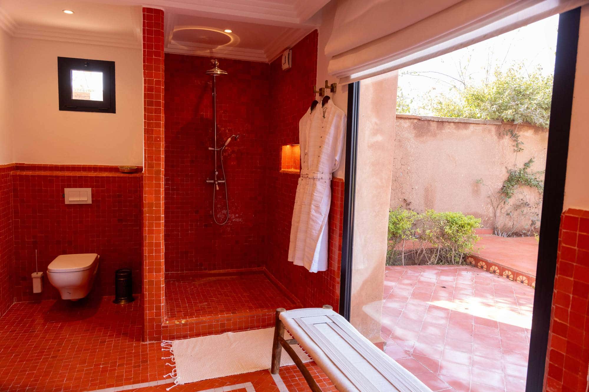 Imi Ouaddar Suite at Villa Yemna in Marrakech, bathroom with shower opening onto the terrace.