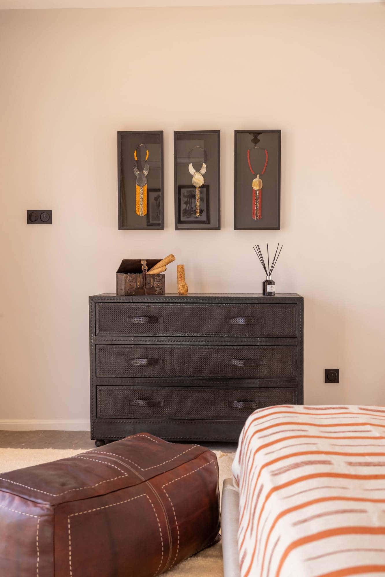 Ourika Suite at Villa Yemna in Marrakech, bedroom with chest of drawers and leather pouf.