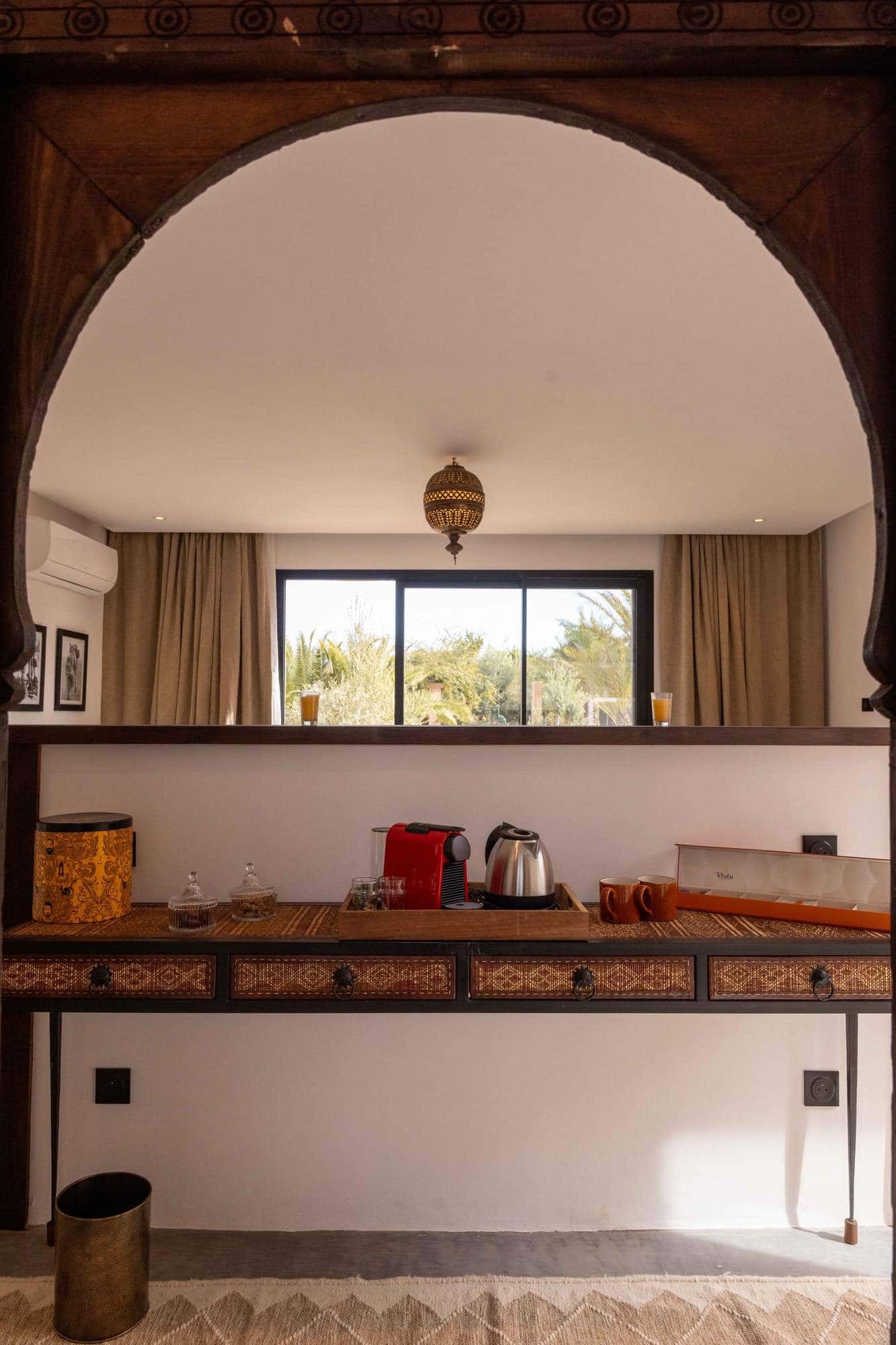 Ourika Suite at Villa Yemna in Marrakech, kitchenette with coffee machine, window view.