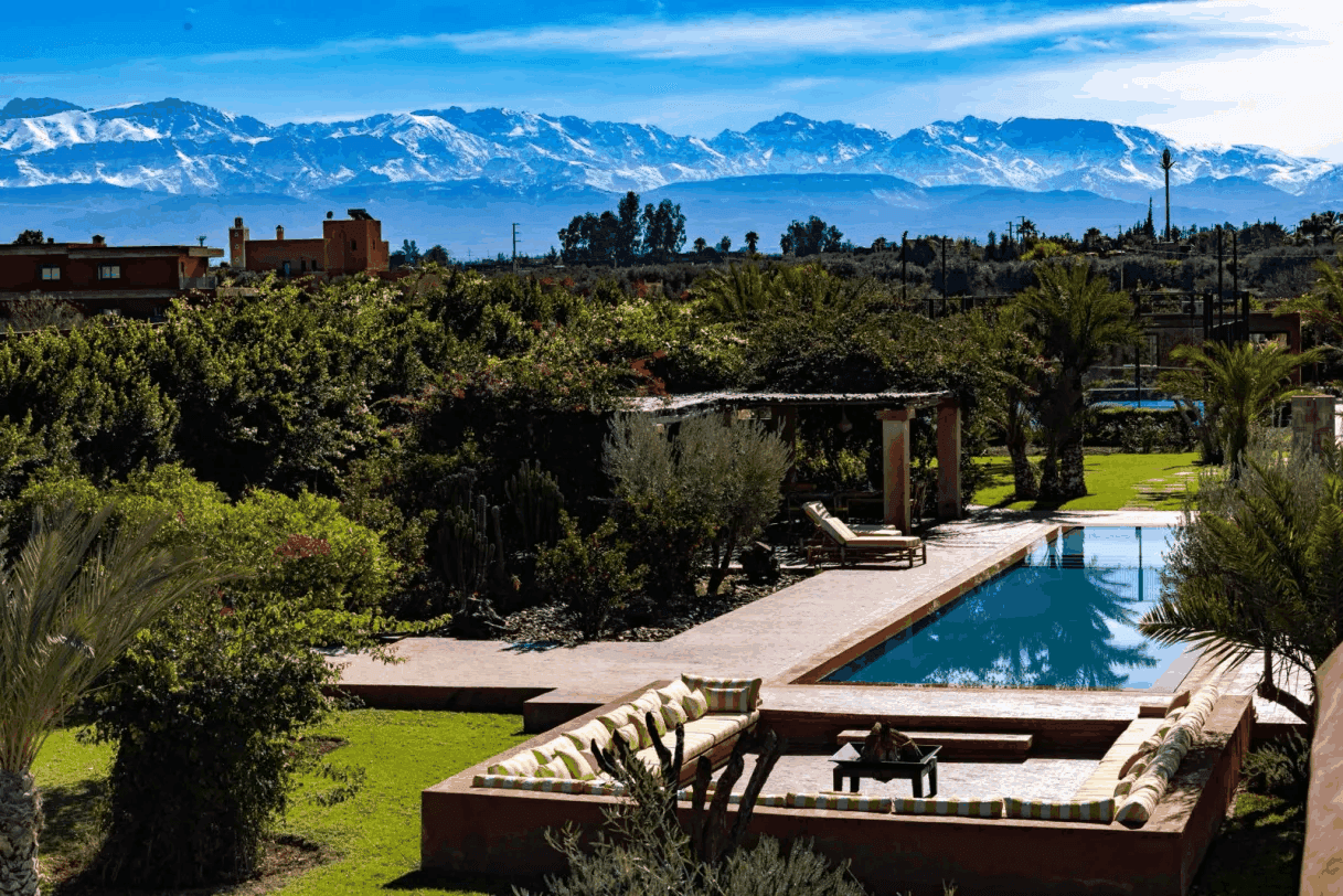 Villa Yemna pool in winter with snow-capped Atlas views